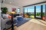 Enjoy light pouring through avant-garde windows in living room and kitchen spaces